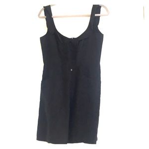 Black linen dress with ruffle details and pockets.